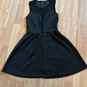 Sleeveless black dress with mesh neckline